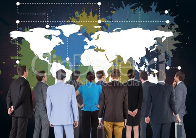 Business people in group looking at Colorful Map with paint splatters on wall background