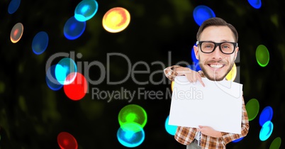 Digital composite image of nerd pointing at placard against colorful lights
