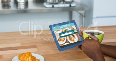 Hand ordering food using digital tablet while having coffee