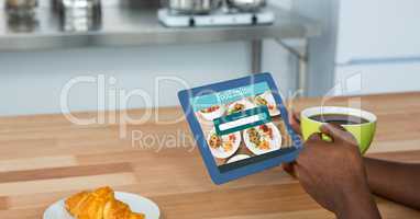 Hand ordering food using digital tablet while having coffee