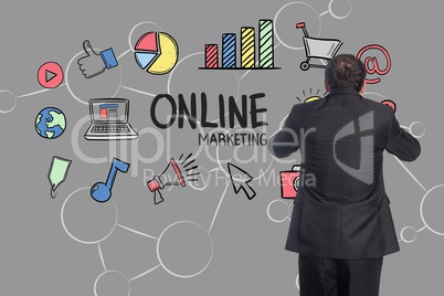 Digital composite image of businessman against various icons and graphs on gray background