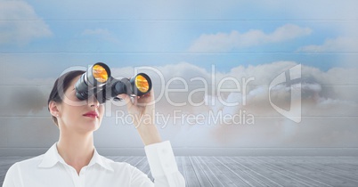 Businesswoman looking through binoculars