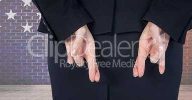 Midsection rear view of businesswoman with fingers crossed