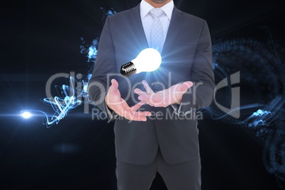 Midsection of businessman with light bulb