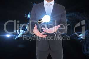 Midsection of businessman with light bulb