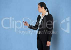 Businesswoman using smart phone against blue background