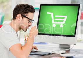 Man using Computer with Shopping trolley icon with coffee