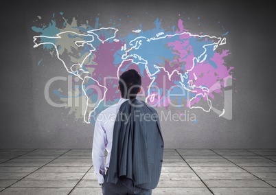 Businessman looking at Colorful Map with paint splattered wall background