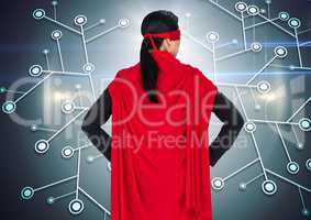 Back of business woman superhero with hands on hips against network and flares