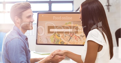 Man and woman shaking hands with search screen on monitor