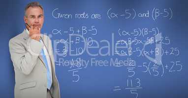 Thoughtful businessman standing by math equation