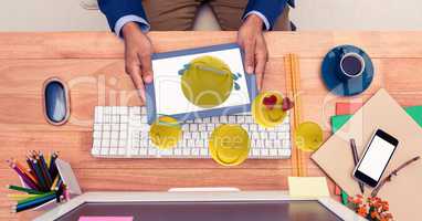 Emojis coming out of tablet PC held by businessman