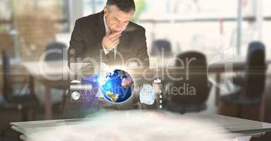 Digital composite image of businessman working at futuristic desk