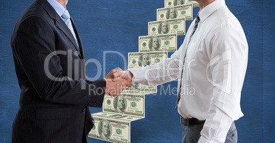 Midsection of businessmen shaking hands with money ladder in background