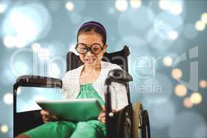 Girl in wheelchair using digital tablet