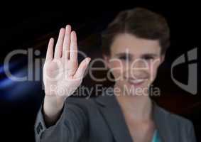 Woman waving with dark background