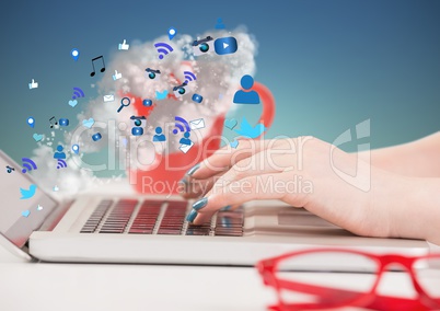 Hands on laptop with icons and clouds coming from screen against blue green background
