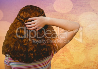 Back of girl with hand on hair against map with bokeh