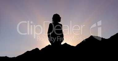 Silhouette executive standing on mountain during sunset