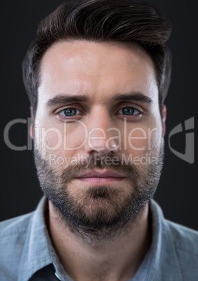 Close up of man's face against dark grey background