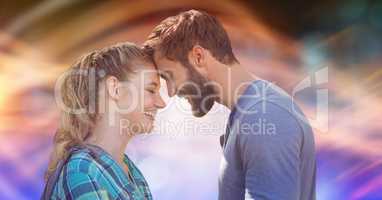 Side view of loving couple with head to head over blur background