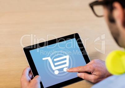 Man using Tablet with Shopping trolley icon
