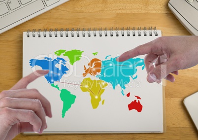 Hands pointing at America and Russia on Colorful Map on a notepad
