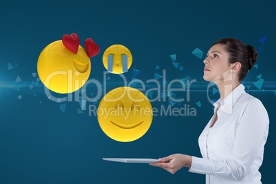 Composite image of businesswoman using a tablet
