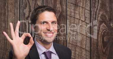 Happy businessman against  wooden background