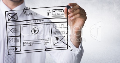Business man mid section with marker and website mock up against white wall