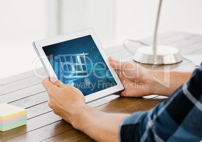 Person using Tablet with Shopping trolley icon