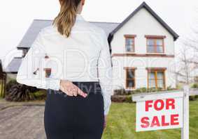 Property seller woman with her fingers crossed