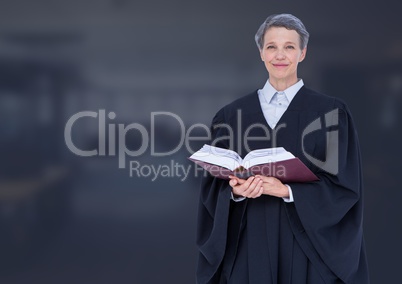 Judge holding book in front of dark office background