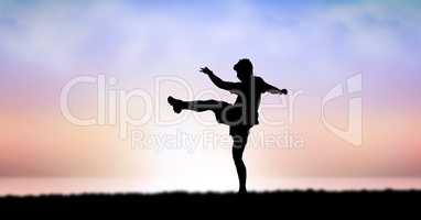 Silhouette of man exercising against sky during sunset