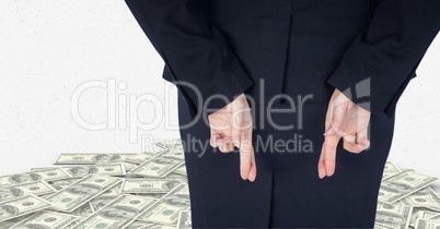Midsection of businesswoman crossing fingers with banknotes in background