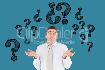 Digital composite image of confused businessman with question marks flying against blue background