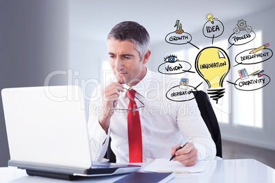 Digital composite image of businessman using laptop by various icons in office