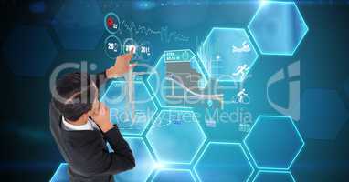 Digitally generated image of businessman touching futuristic screen