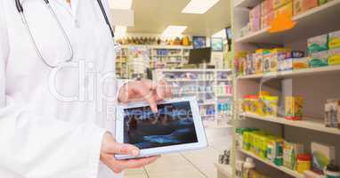 Doctor using digital tablet in pharmacy