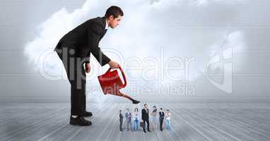 Digital composite image of businessman watering colleagues on boardwalk