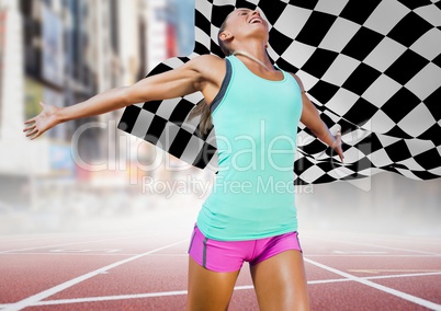 Female runner on track against blurry street and checkered flag