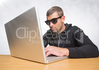 Man with sunglasses on laptop