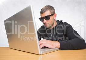 Man with sunglasses on laptop