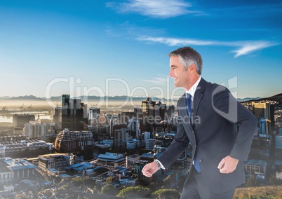 Walking businessman over city