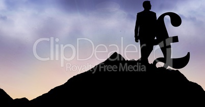 Silhouette businessman with pound sign on mountain against sky
