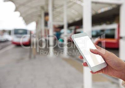 Hand with mobile in the bus station