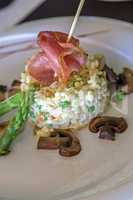 Risotto with mushrooms, fresh herbs and parmesan ham