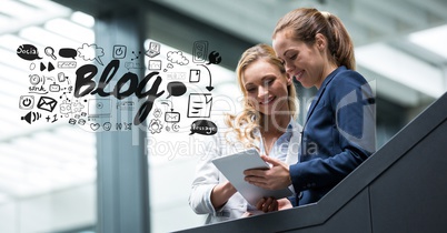 Digital composite image of businesswomen using tablet PC with blog graphics