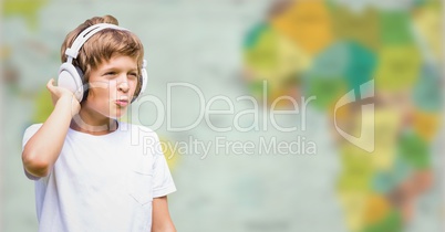 Boy with headphones against blurry map
