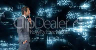 Composite image of businessman against mathematics background